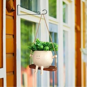 Hanging smiley face on swing pot head planter